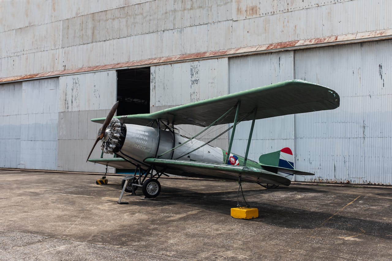 vintage-biplane-parked-outside-hangar-35557241